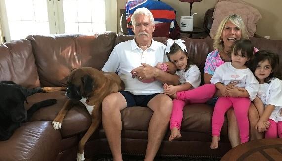 brown couch, a dog, three children, Mr. Skahill and Mrs. Skahill